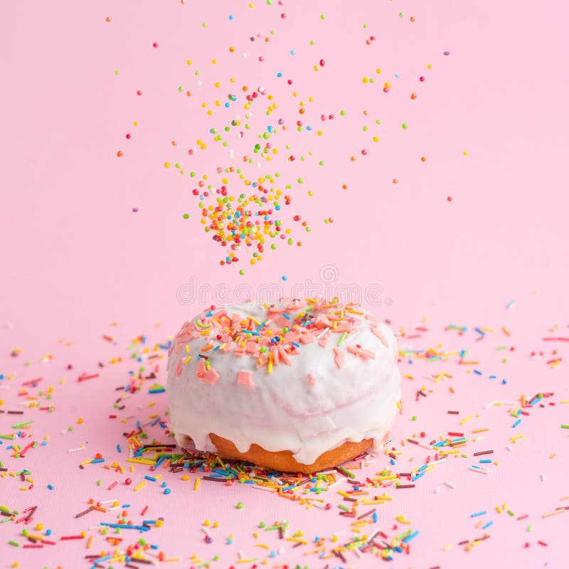 Sprinkle Pink Donut. on a Pink Background with Space for Design Stock