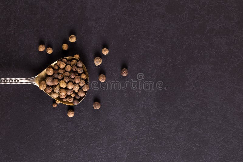 Sprinkled Black Pepper in an Iron Spoon. Concept, Copy Space Stock