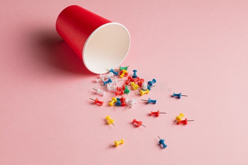 Sprinkled colorful different pins in the open bottle. royalty free stock photo Sprinkled colorful different pins in the open bottle. royalty free stock photo