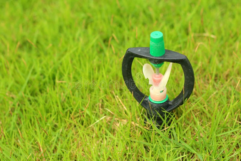 Sprinkler is Stuck in in the Grass. Stock Photo Image of farm, grass 44227960