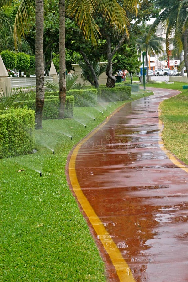 Sprinkler watering stock photos