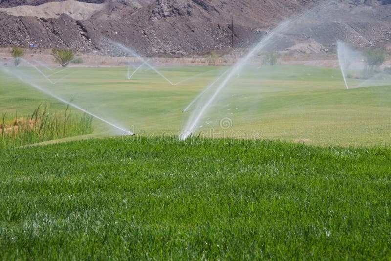 Sprinklers on golf course stock photo. Image of irrigation 15779470