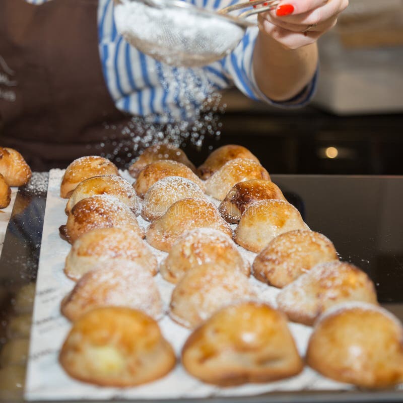 Sprinklng Icing Sugar on Neapolitan Pastry: Group of Filled Pastries on ...