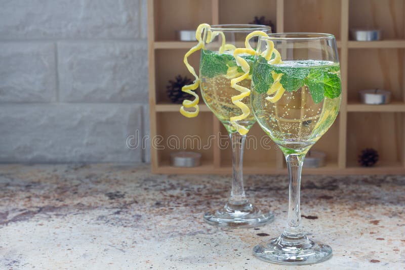 Spritzer cocktail with white wine, mint and ice, decorated with spiral lemon zest, copy space stock photography Spritzer cocktail with white wine, mint and ice, decorated with spiral lemon zest, copy space stock photography