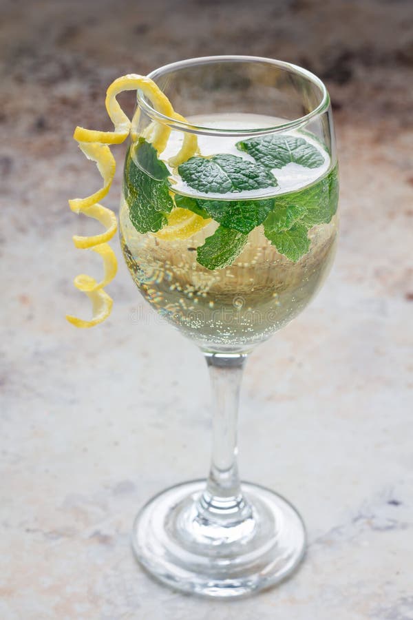 Spritzer Cocktail with White Wine, Mint and Ice, Decorated with Spiral