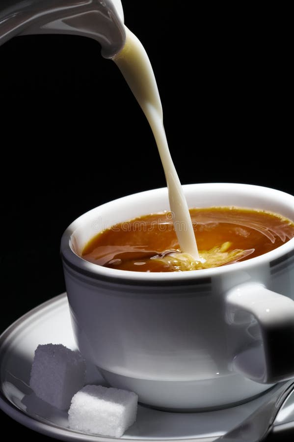 View of nice fresh milk stream flowing down in to the cup of coffee. View of nice fresh milk stream flowing down in to the cup of coffee