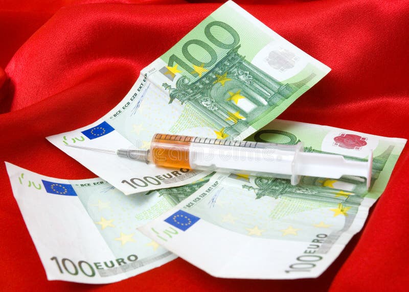 Syringe and money on a red background. Syringe and money on a red background