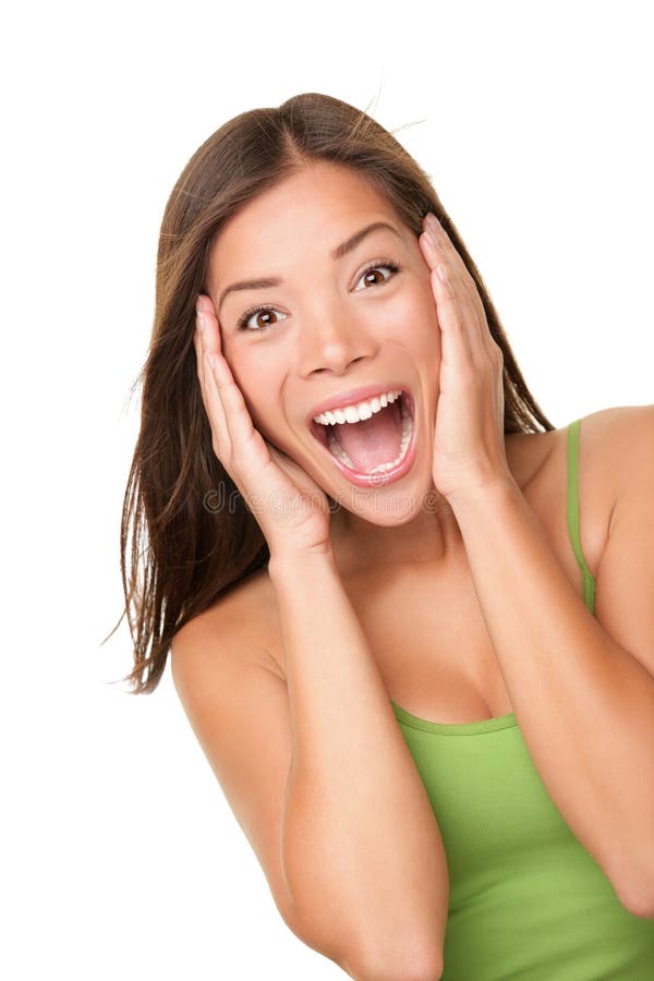 Surprised excited woman screaming amazed in joy. Beautiful young woman isolated on white background in casual green tank top. Asian Caucasian multiracial female model in her 20s. Surprised excited woman screaming amazed in joy. Beautiful young woman isolated on white background in casual green tank top. Asian Caucasian multiracial female model in her 20s.