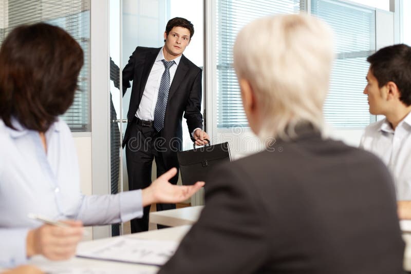 Office worker coming late to meeting. Office worker coming late to meeting