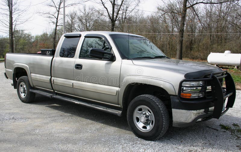 Late model Chevrolet pickup truck, 2500 series. Silver with tinted windows, extended cab, grill guard, 4 wheel drive and toolbox. Late model Chevrolet pickup truck, 2500 series. Silver with tinted windows, extended cab, grill guard, 4 wheel drive and toolbox.