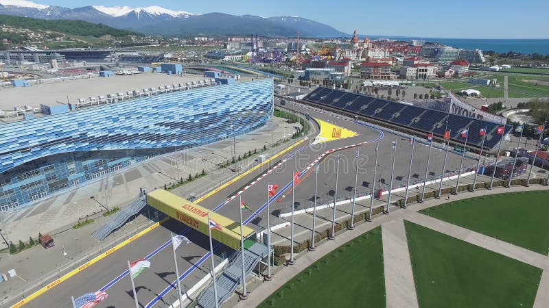 The formula 1 track in Sochi, the Olympic village in Sochi. Building site of stadium for racing near town and mountains at summer sunny day. Aerial view. Aerrial view on pectator stands F1 Russian Grand Prix Sochi Circuit. The formula 1 track in Sochi, the Olympic village in Sochi. Building site of stadium for racing near town and mountains at summer sunny day. Aerial view. Aerrial view on pectator stands F1 Russian Grand Prix Sochi Circuit.