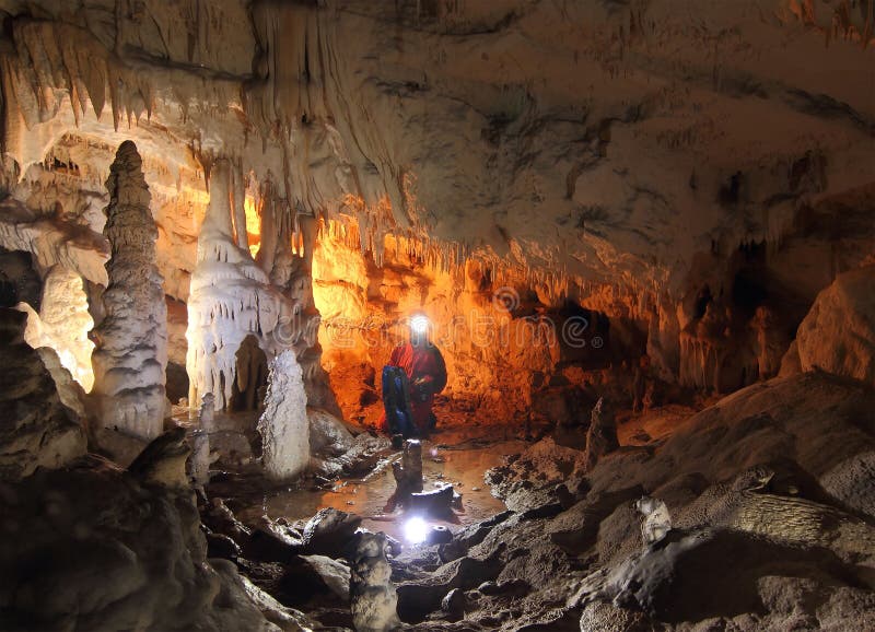 Speleologist exploring the cave in Romania. Speleologist exploring the cave in Romania