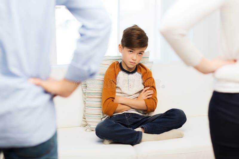 People, misbehavior, family and relations concept - close up of upset or feeling guilty boy and parents at home. People, misbehavior, family and relations concept - close up of upset or feeling guilty boy and parents at home