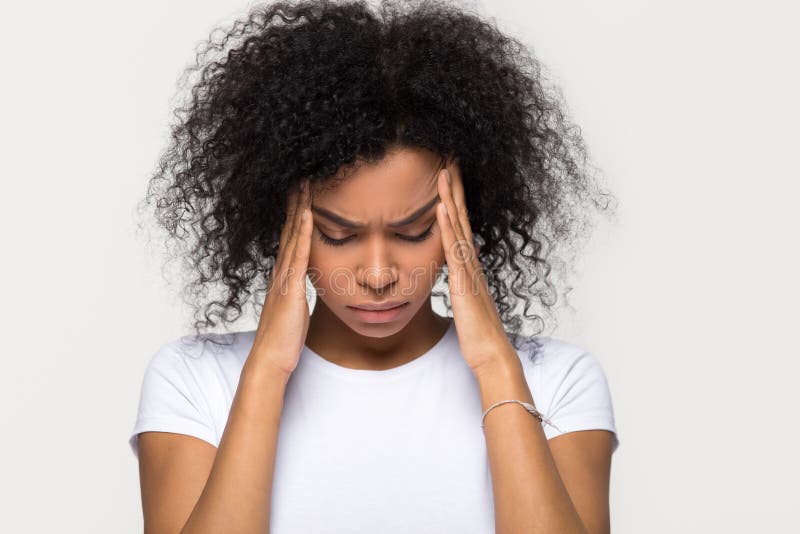 Upset stressed black woman massaging temples feeling pain terrible migraine, sad tired sick african american girl suffering from strong headache concept isolated on grey white blank studio background. Upset stressed black woman massaging temples feeling pain terrible migraine, sad tired sick african american girl suffering from strong headache concept isolated on grey white blank studio background