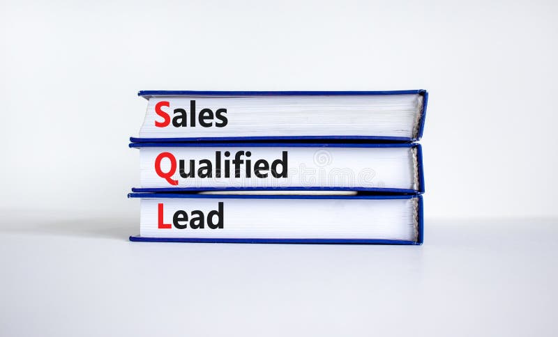 SQL sales qualified lead symbol. Books with words `SQL sales qualified lead`. Beautiful white background. Business and SQL sales stock photos