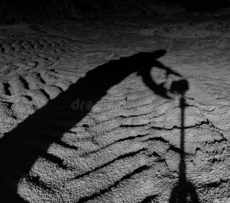 Square black and white scary man shadow taking photo camera
