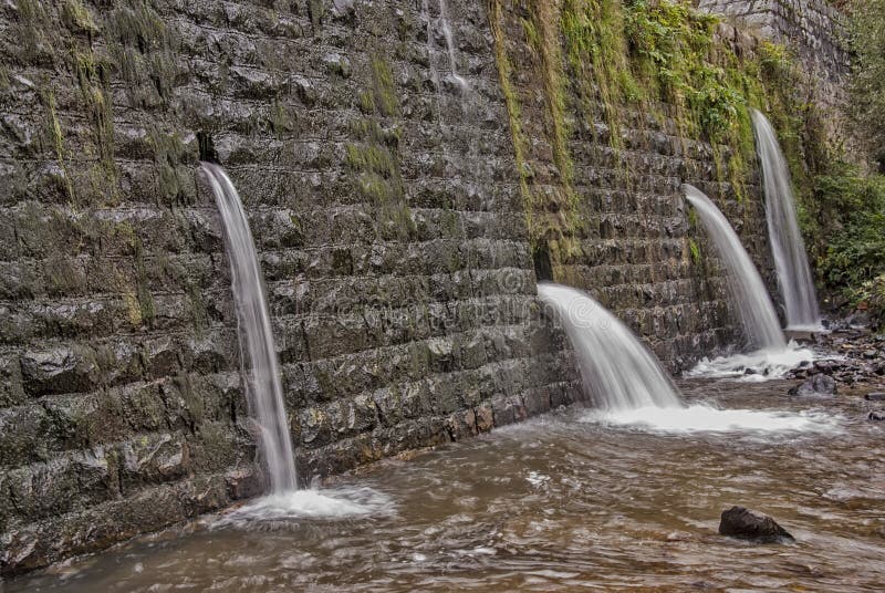 Square Concrete Blocks Dam on the River with Holes for Drain Water
