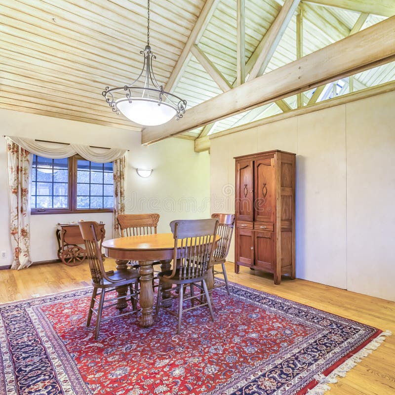 Square Frame Dining Room with Vaulted Ceilings and Modern Chandelier