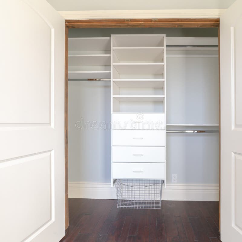 Empty walk in closet of a new home with shelves and metal rods for
