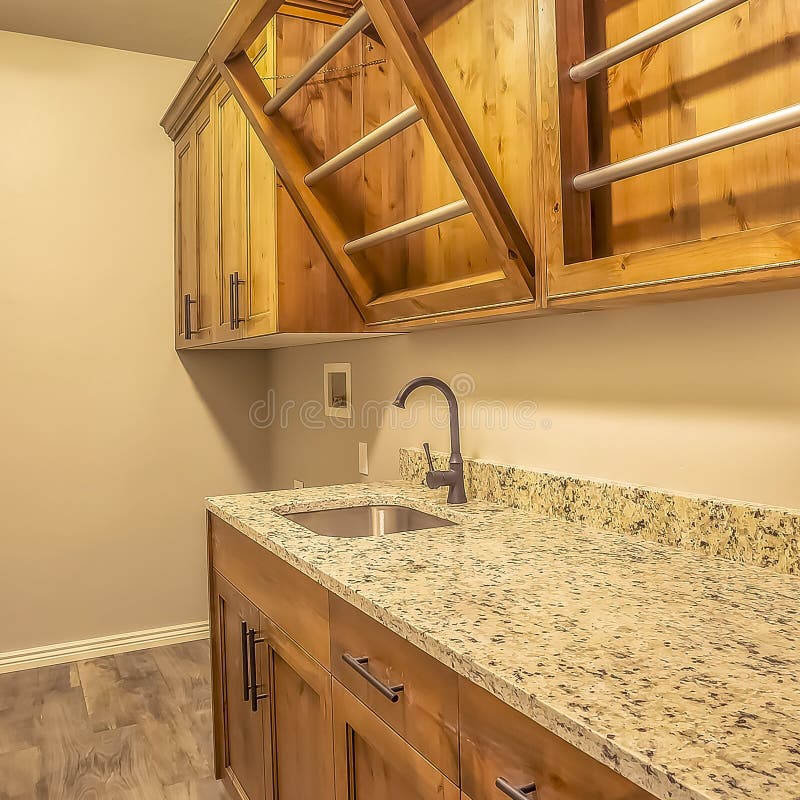 Square Kitchen Interior Of New Home With Dark Wood Cabinets Marble