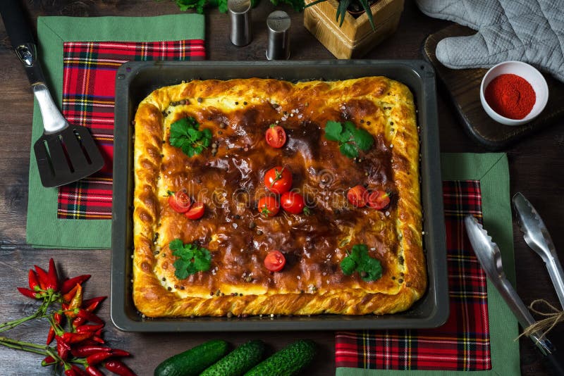 A square meat pie on an iron tray. Greased with butter, sprinkled with pepper and salt. Country style stock images A square meat pie on an iron tray. Greased with butter, sprinkled with pepper and salt. Country style stock images
