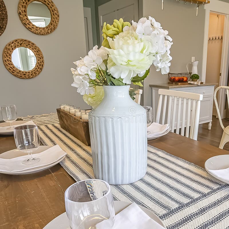 Square Table Setting Inside a Dining Room with Brown Table and White