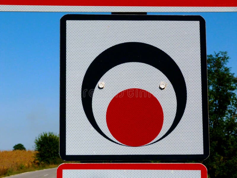 square traffic sign with black, red and white circles and blurry blue background stock photography square traffic sign with black, red and white circles and blurry blue background stock photography