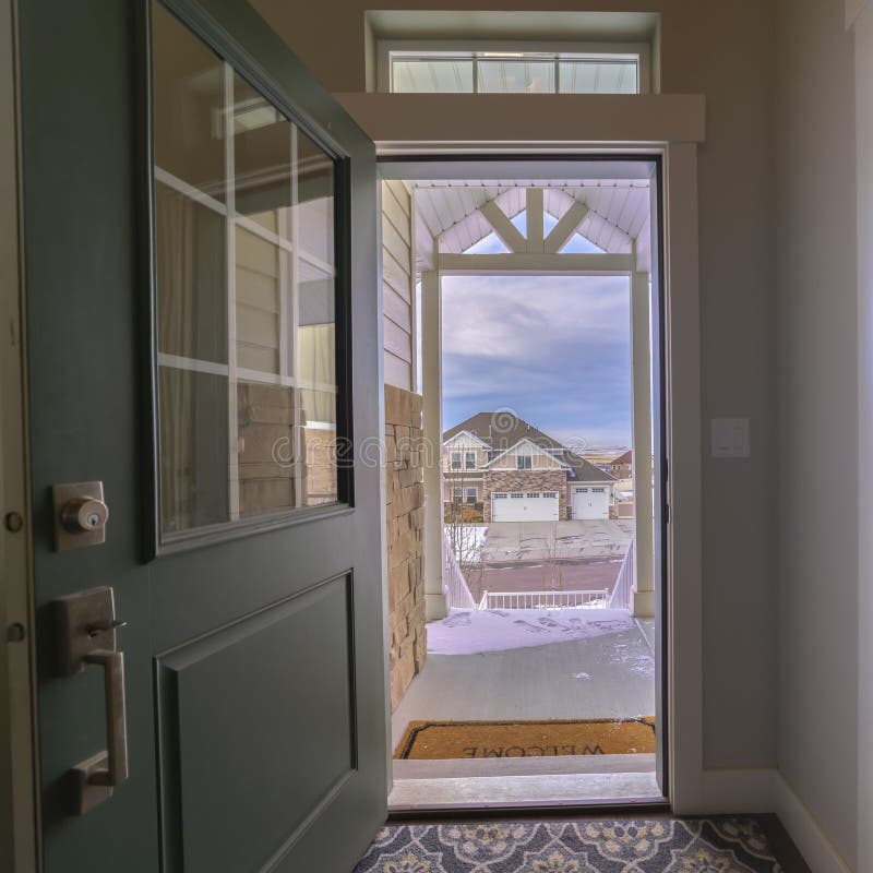 Exterior View Of The Open Front Door To A Residence With The