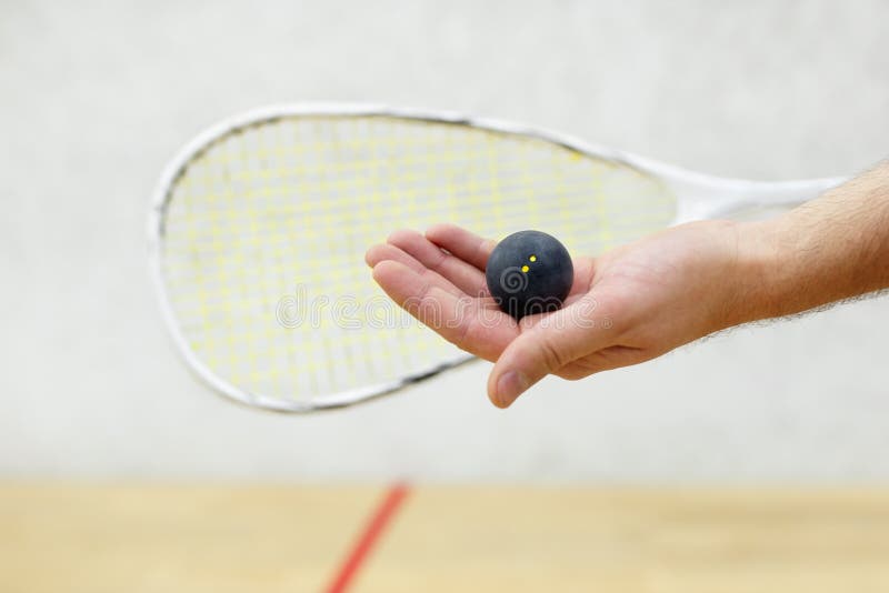 Squash player serving a ball