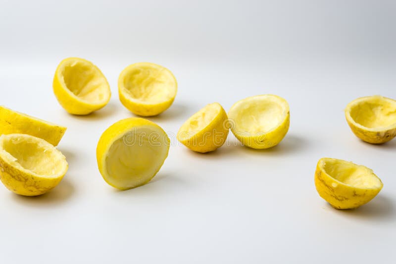 Squeezed lemon peels after making a fresh juice on white background