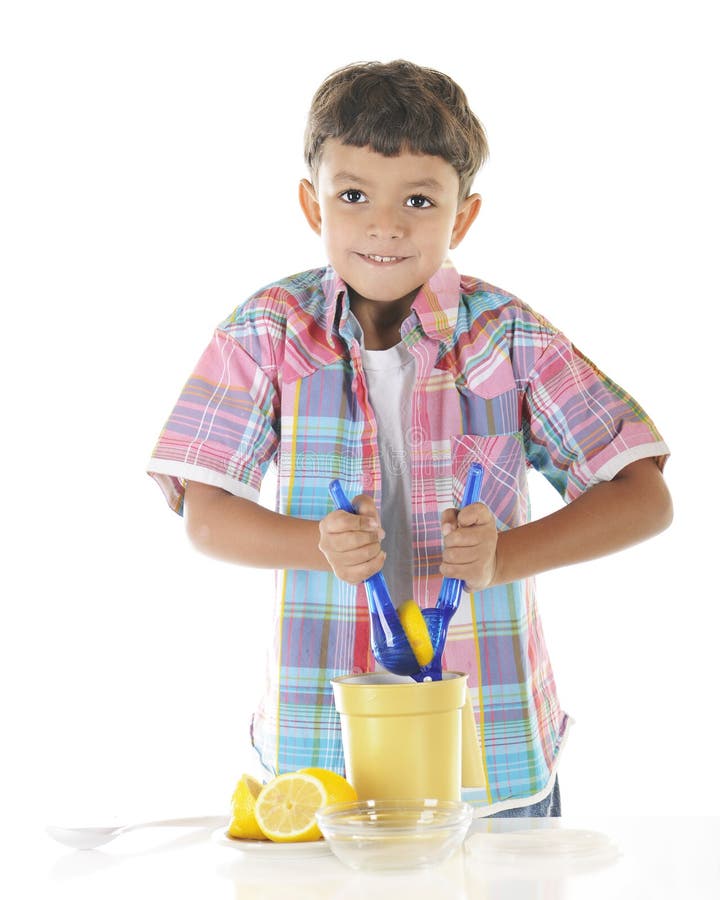 An adorable preschooler strains as he attempts to squeeze a lemon as he's making lemonade. On a white background. An adorable preschooler strains as he attempts to squeeze a lemon as he's making lemonade. On a white background.