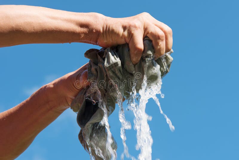 https://thumbs.dreamstime.com/b/squeezing-cloth-hands-squeeze-wet-fabric-against-blue-sky-58977665.jpg