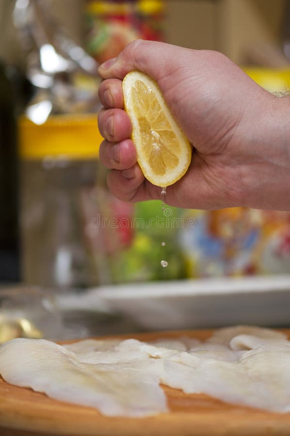 Squeezing Lemon Juice on Fish Fillets Stock Image Image of dinner