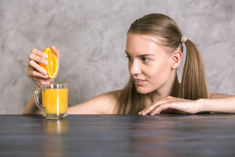 Squeezing orange on table royalty free stock photos Squeezing orange on table royalty free stock photos