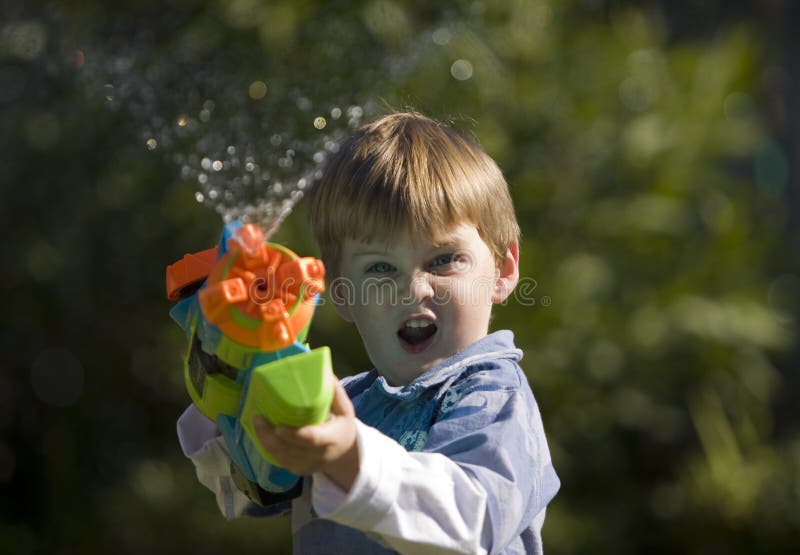 Download Squirt Gun Kid stock image. Image of closeup, action - 13404383