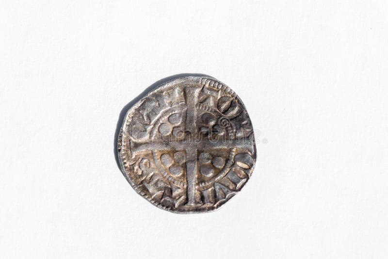 Silver long cross penny English hammered coin of King Henry II of the 14th century dated around 1310- 1314 minted in Canterbury England, reverse cut out and isolated on a white background, stock photo. Silver long cross penny English hammered coin of King Henry II of the 14th century dated around 1310- 1314 minted in Canterbury England, reverse cut out and isolated on a white background, stock photo