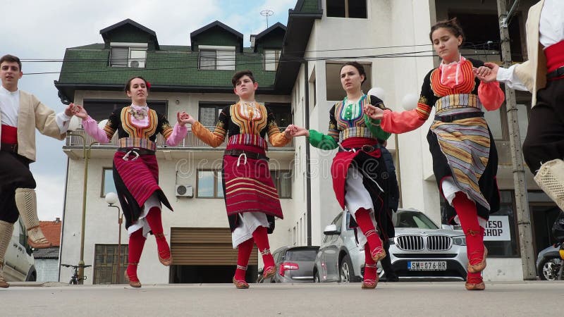 Sremska Mitrovica, Serbia, 02.19.22 Girls boys in traditional Serbian Balkan costumes dance Kolo Kolov. A circle dance