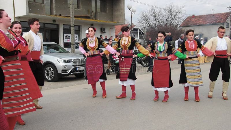 Sremska Mitrovica, Serbia, 02.19.22 Girls boys in traditional Serbian Balkan costumes dance Kolo Kolov. A circle dance