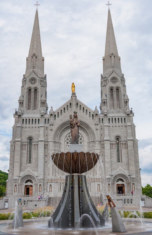 Front of the Basilica of Sainte-Anne-de-BeauprÃ© church in Quebec Canada with statues and a fountain