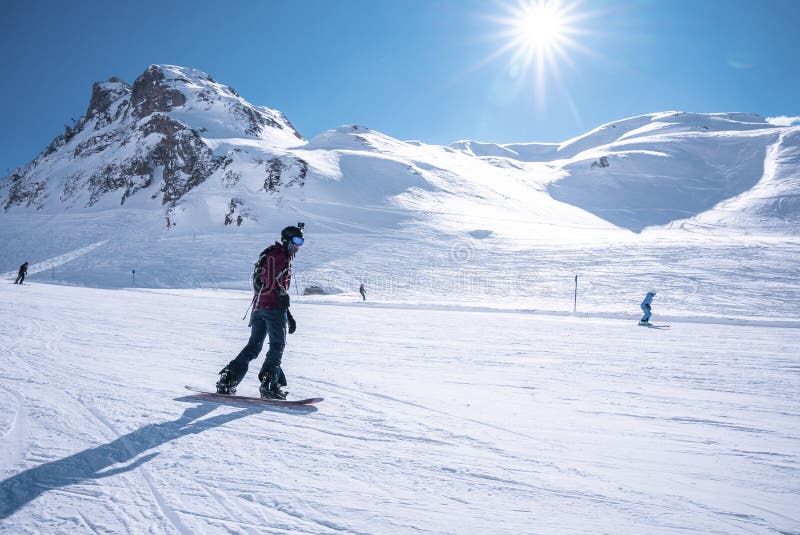 Young Snowboarder Sliding Down Snowy Slope on Mountain at Winter Resort ...