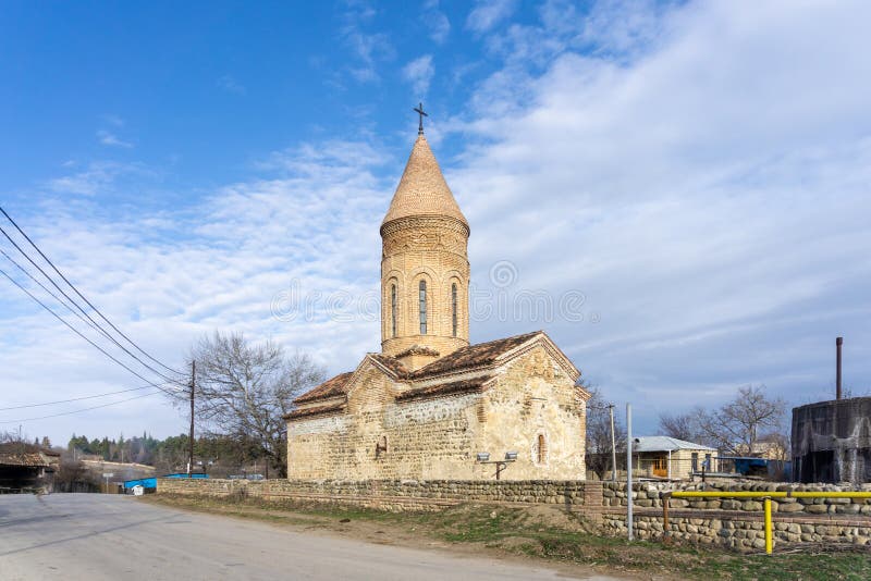 St. Archangels church of Machkhaani village. Stone walls, tile dome. Bright blue sky with clouds. St. Archangels church of Machkhaani village. Stone walls, tile dome. Bright blue sky with clouds.