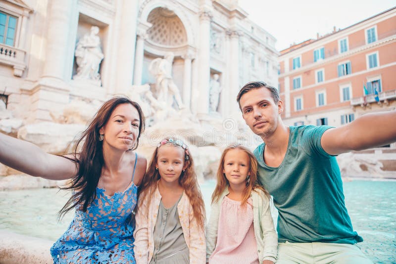 St?ende av familjen p? Fontana di Trevi, Rome, Italien royaltyfria bilder St?ende av familjen p? Fontana di Trevi, Rome, Italien royaltyfria bilder
