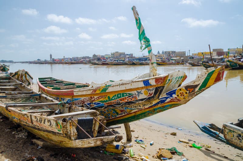 St Louis, Senegal - October 12, 2014: Colorful painted wooden fishing boats or pirogues at coast of St. Louis royalty free stock photos St Louis, Senegal - October 12, 2014: Colorful painted wooden fishing boats or pirogues at coast of St. Louis royalty free stock photos