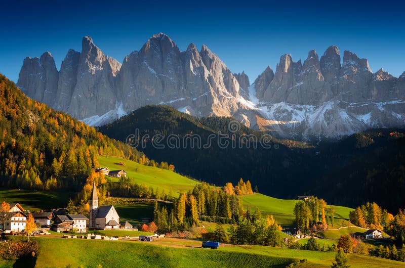 St. Magdalena or Santa Maddalena village with its church in front of the Geisler Dolomites mountain peaks in the Val di Funes Valley (Villnoesstal) in South Tyrol, Italy in autumn. St. Magdalena or Santa Maddalena village with its church in front of the Geisler Dolomites mountain peaks in the Val di Funes Valley (Villnoesstal) in South Tyrol, Italy in autumn.