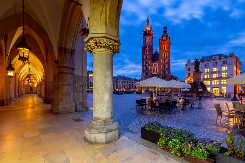Krakow. St. Mary`s Church and market square at dawn. St. Mary`s Church on the market square in night lighting. Krakow. Poland stock images Krakow. St. Mary`s Church and market square at dawn. St. Mary`s Church on the market square in night lighting. Krakow. Poland stock images