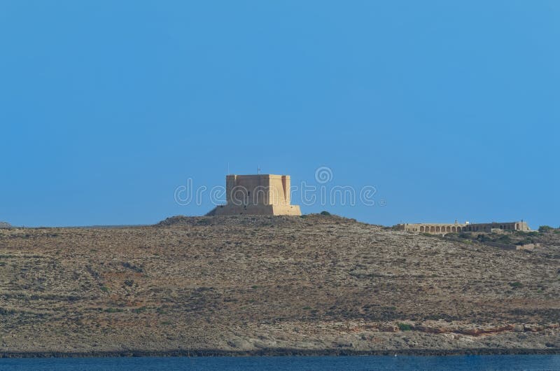St Mary`s Tower - fortification on the island of Comino, Malta. St Mary`s Tower - fortification on the island of Comino, European island state of Malta stock photo St Mary`s Tower - fortification on the island of Comino, Malta. St Mary`s Tower - fortification on the island of Comino, European island state of Malta stock photo