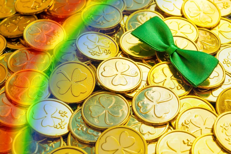 St Patrick`s Day background. Golden coins with shamrock, green bow tie and rainbow, St Patrick`s day symbols royalty free stock photos St Patrick`s Day background. Golden coins with shamrock, green bow tie and rainbow, St Patrick`s day symbols royalty free stock photos