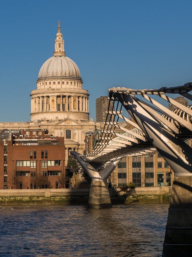 St. Pauls Cathedral and the Millennium Bridge from the south bank of the River Thames. London, England, UK. St. Pauls Cathedral and the Millennium Bridge from the south bank of the River Thames. London, England, UK.