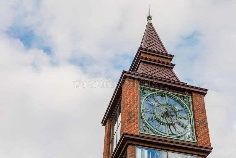 St. Petersburg, Russia -23. 23. 2018: a fragment of a modern clock tower on a background of cloudy sky. Vintage style royalty free stock photo