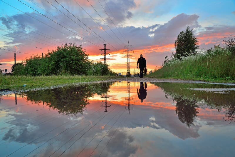 A lonely man and high-voltage power line - power lines reflected royalty free stock photos A lonely man and high-voltage power line - power lines reflected royalty free stock photos
